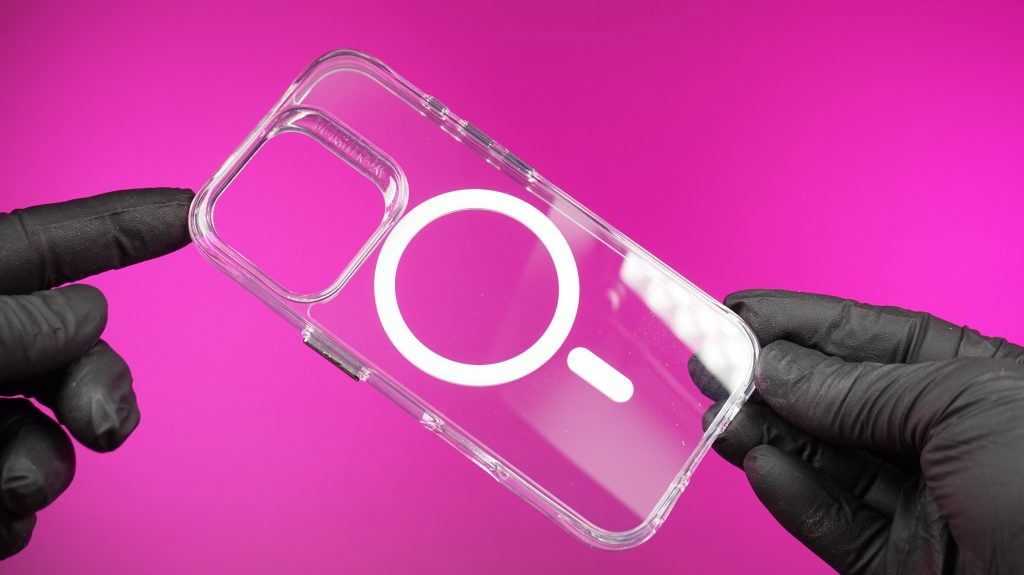 A gloved hand holding a flexible, clear magsafe phone case, a popular item from our mobile phone case sales in dundee.
