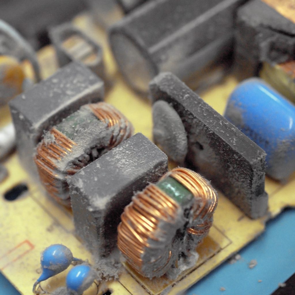 Dusty computer power supply components being cleaned at repair alliance dundee