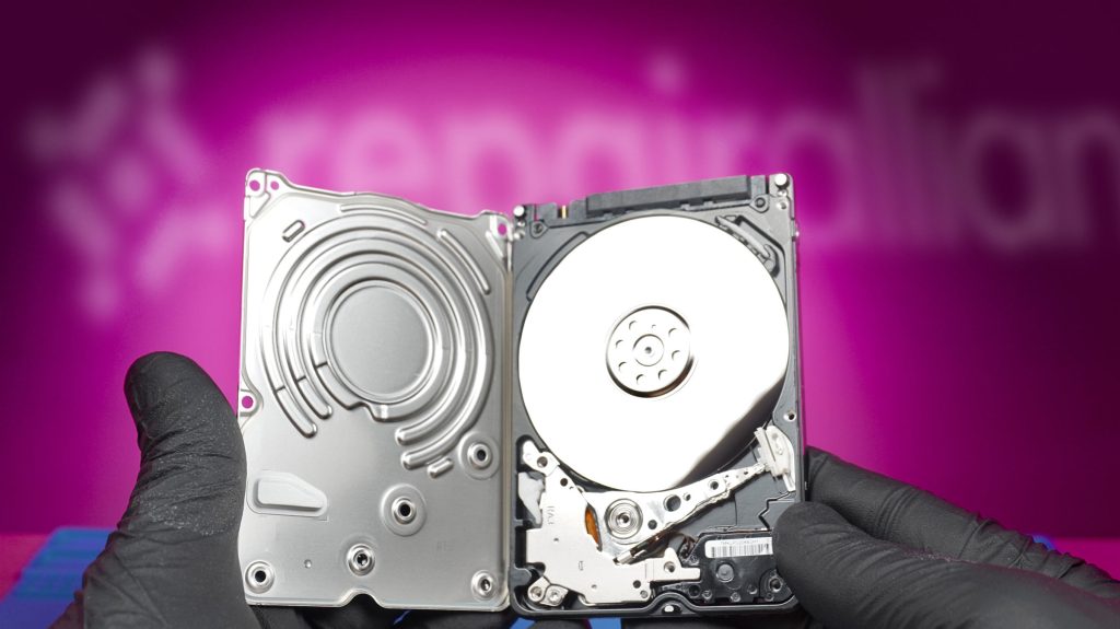 Technician opens faulty laptop/portable hard drive for data recovery repair in dundee