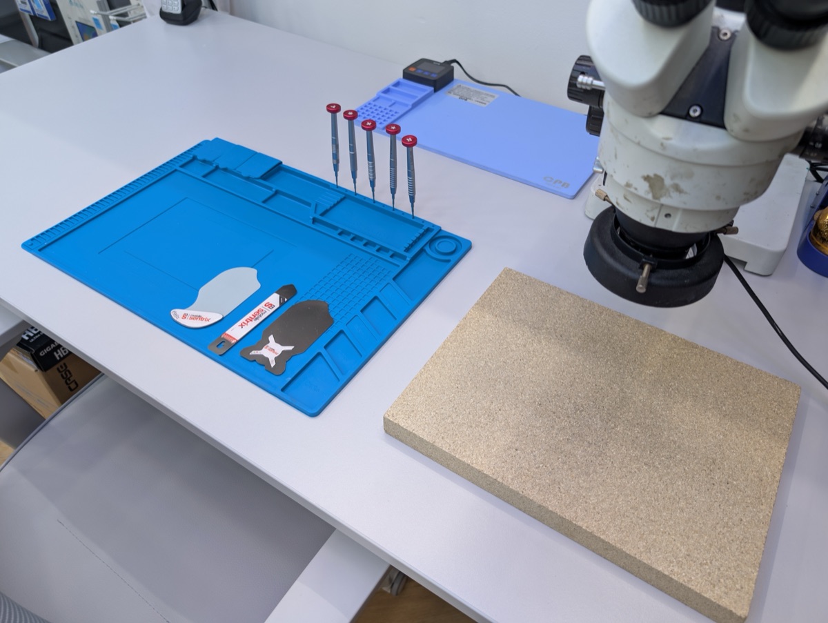 Close-up of repair tools and soldering mat at repair alliance