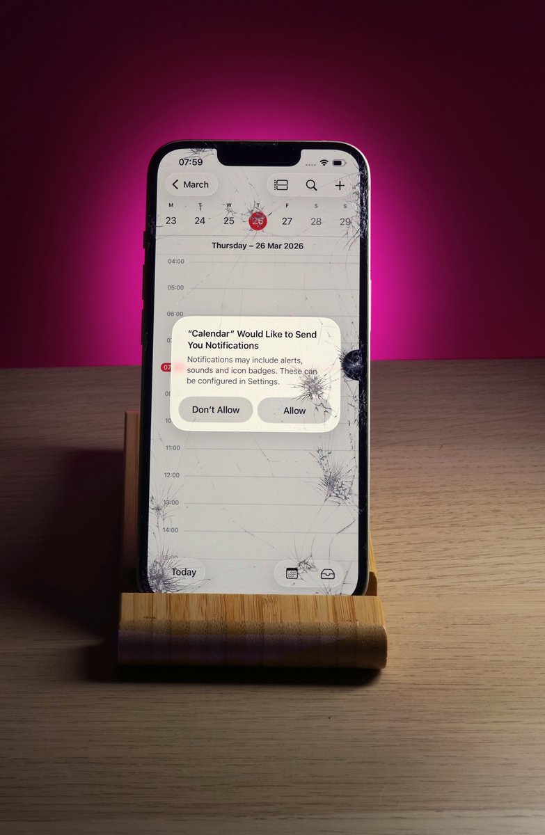 Iphone with cracked screen showing calendar at repair alliance dundee
