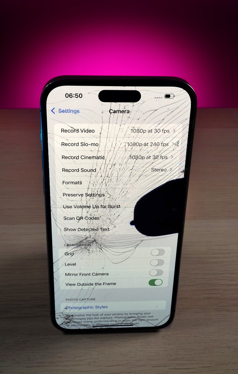 Iphone with cracked screen showing camera settings at repair alliance dundee